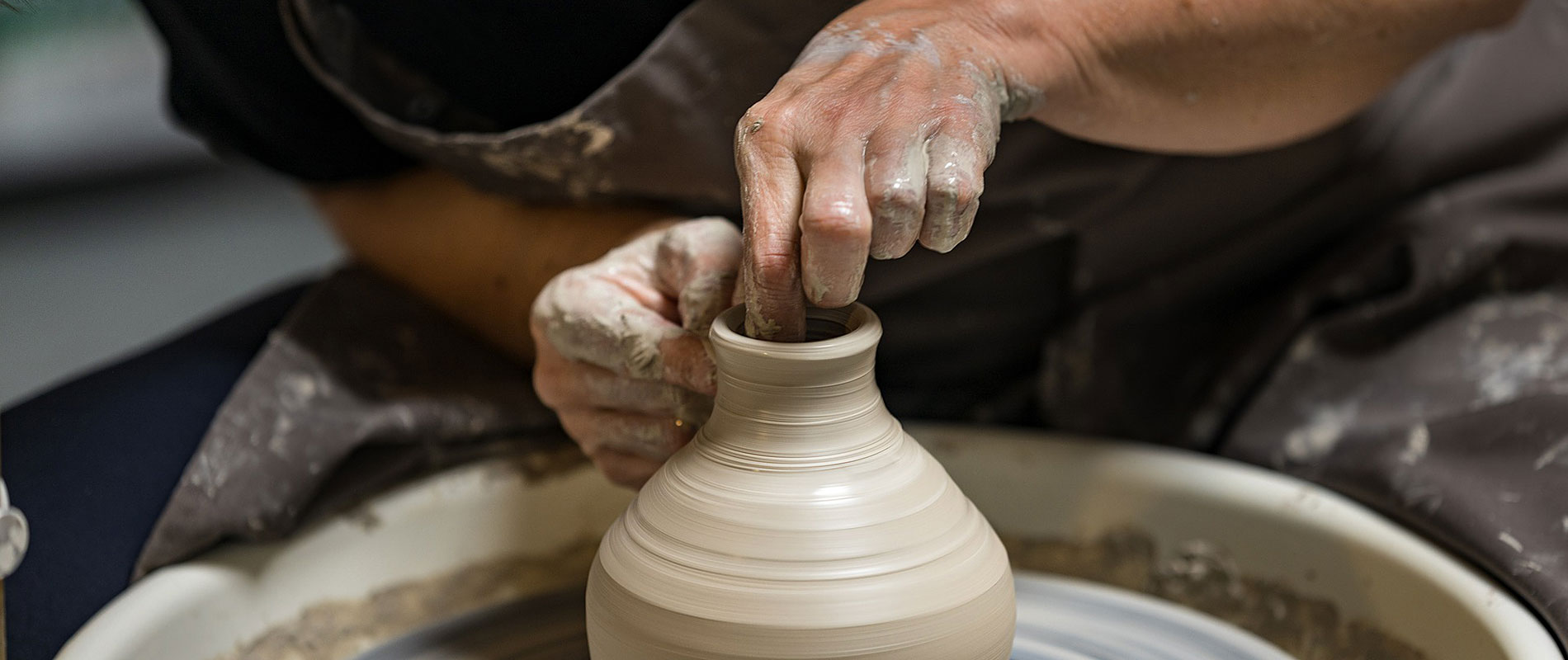 a potter turning a clay pot